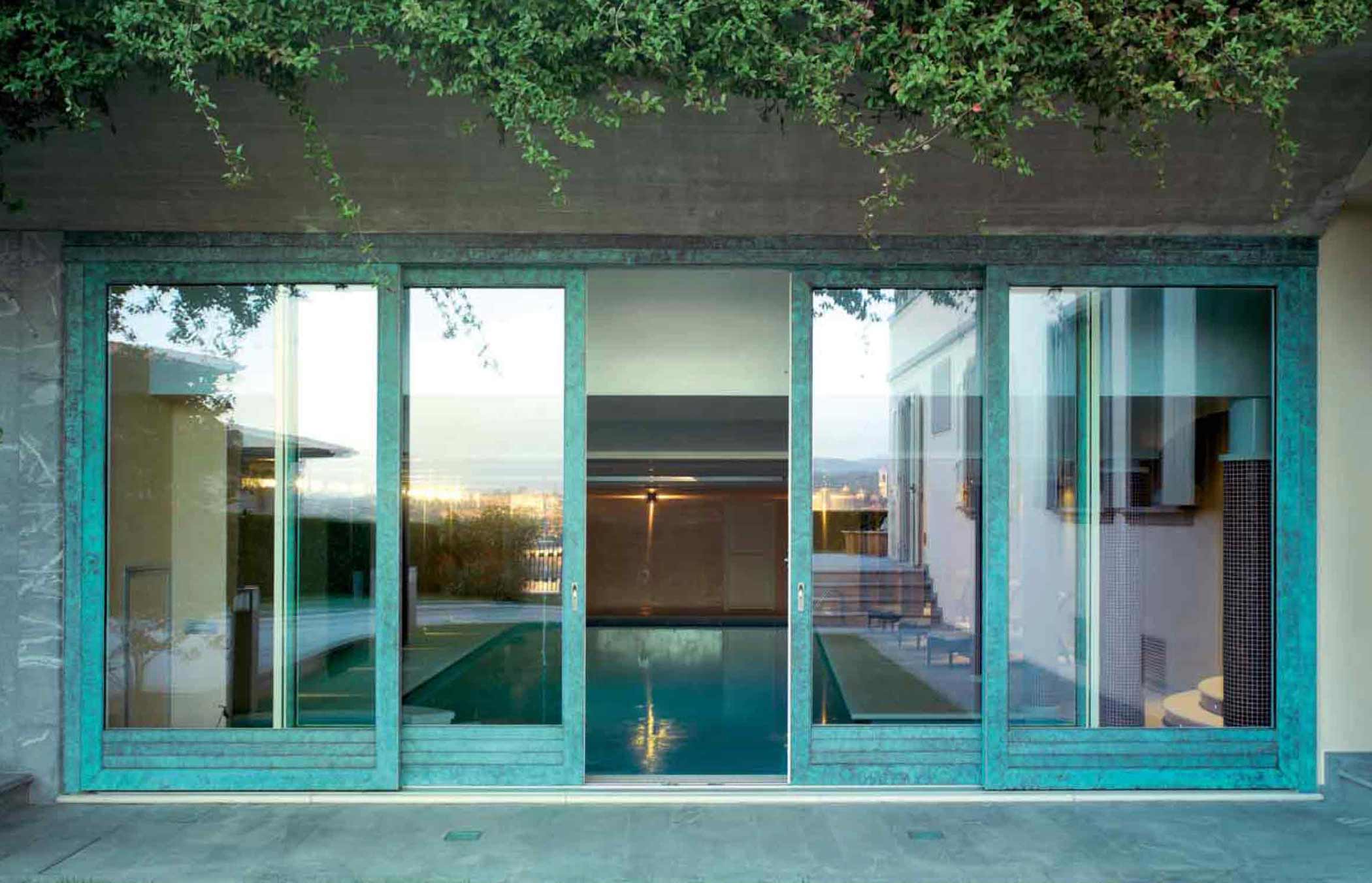 View of a wooden sliding door with the external coppered bronze cladding