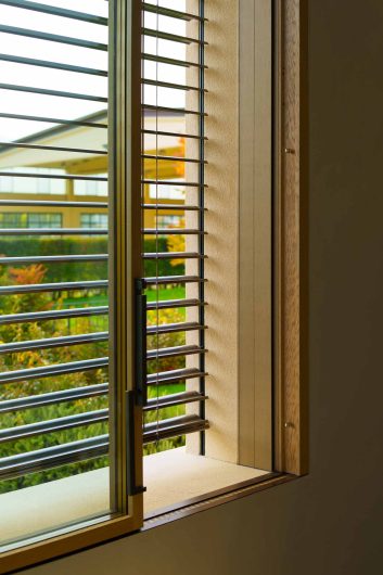 Lift-and-slide window and motorized brise soleil lowered